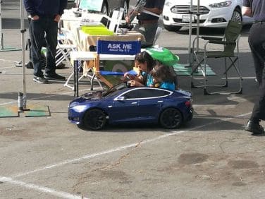 Kids having fun in their mini Tesla at 2019 Drive Electric Earth Day Balboa Park.