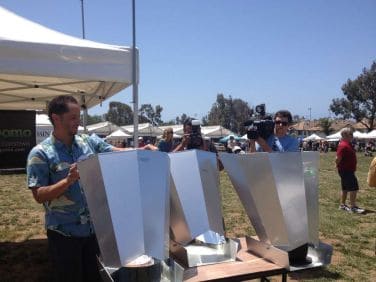 Charlie prepares a solar cooking demonstration. At events, the smell of solar chili and cornbread brings guests to the Makello booth.